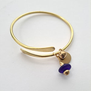 Brass bracelet with blue bead