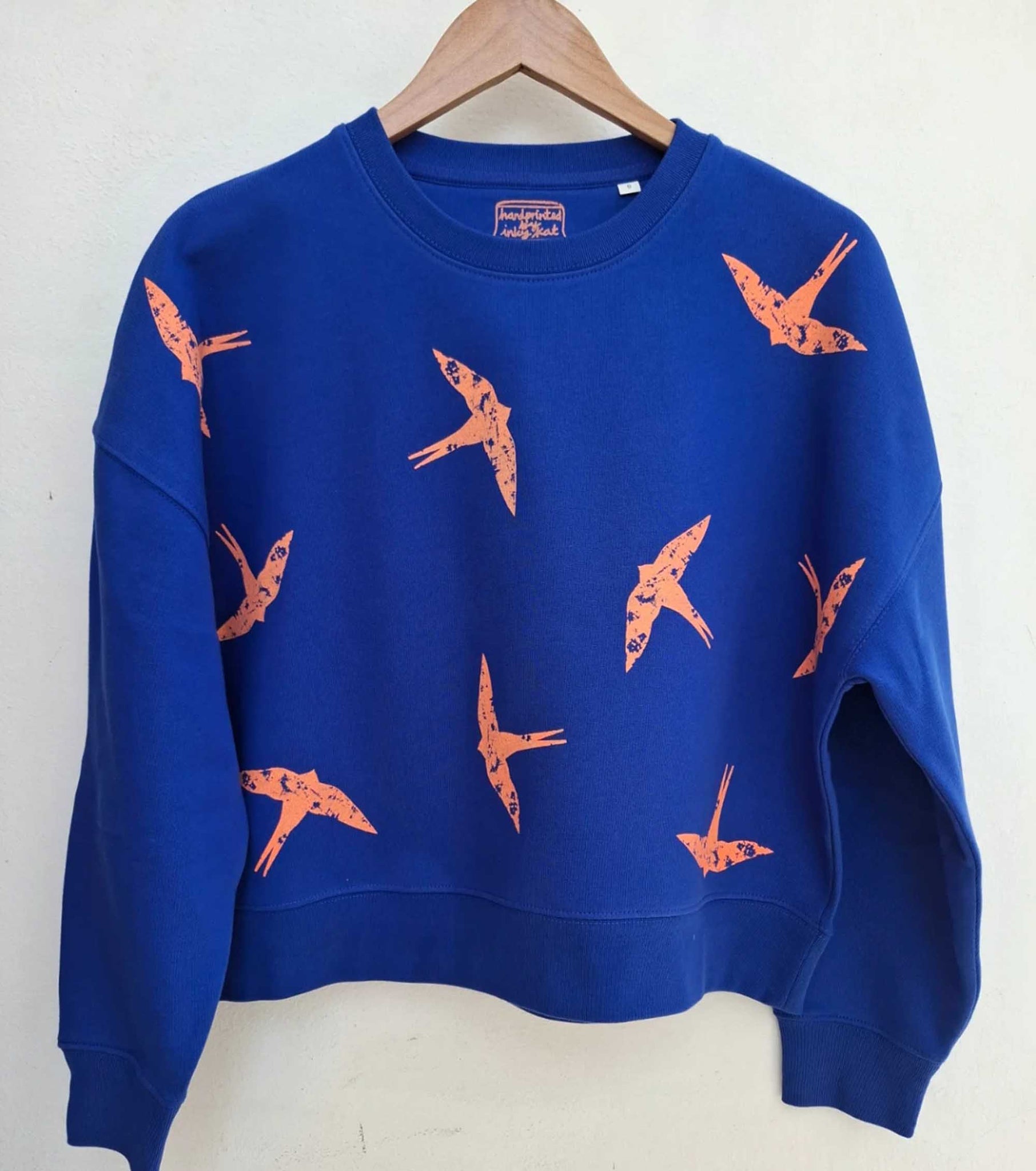 Orange Swallow design blue sweatshirt