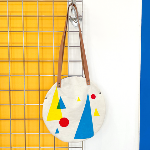 Small primary colour triangle and circle design circular bag
