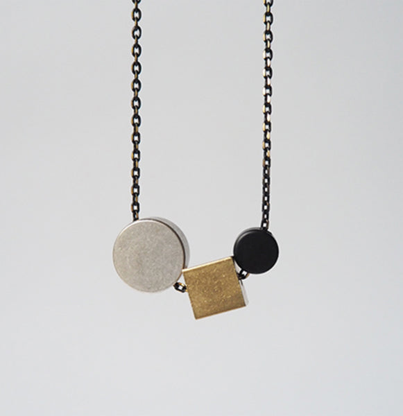 Silver circle + brass cube + black disc necklace